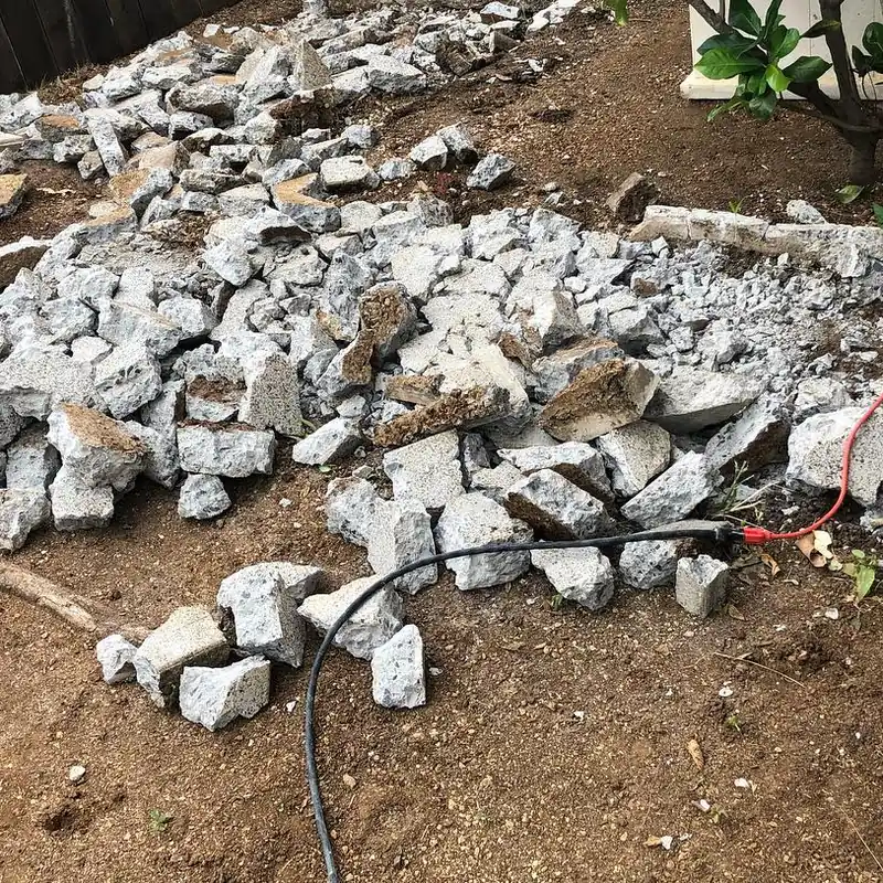 A broken-up slab of concrete piled in a yard, ready to be loaded out.